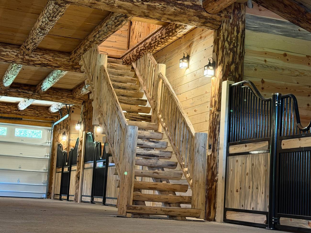 Log stair and stalls inside the barn