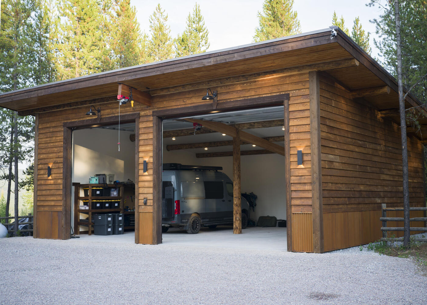 The garage with both doors open showing the timber posts and beam carrying the roof