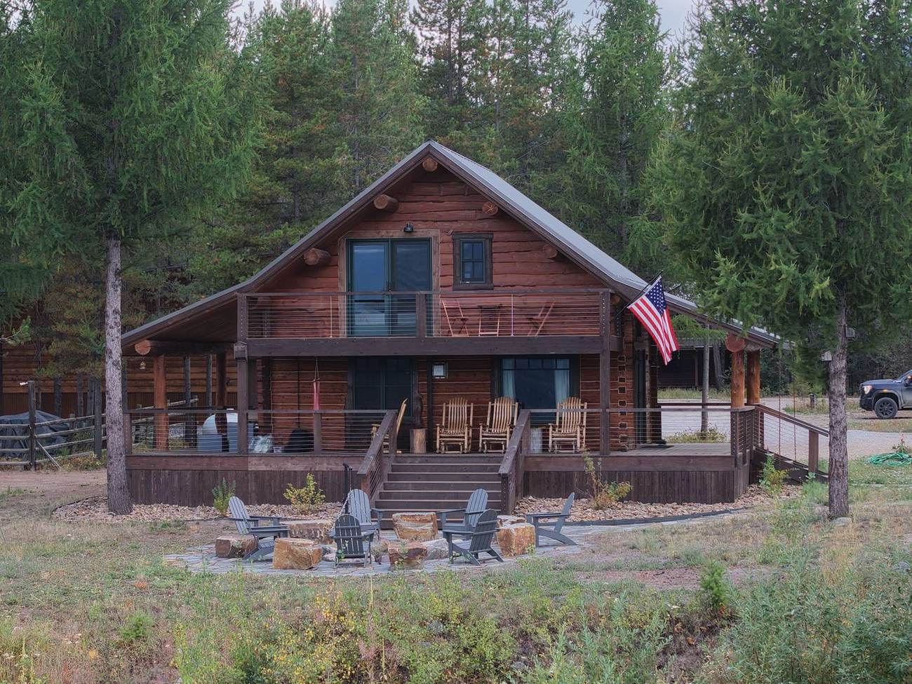 Cabin elevation in evening light with the fire pit in front